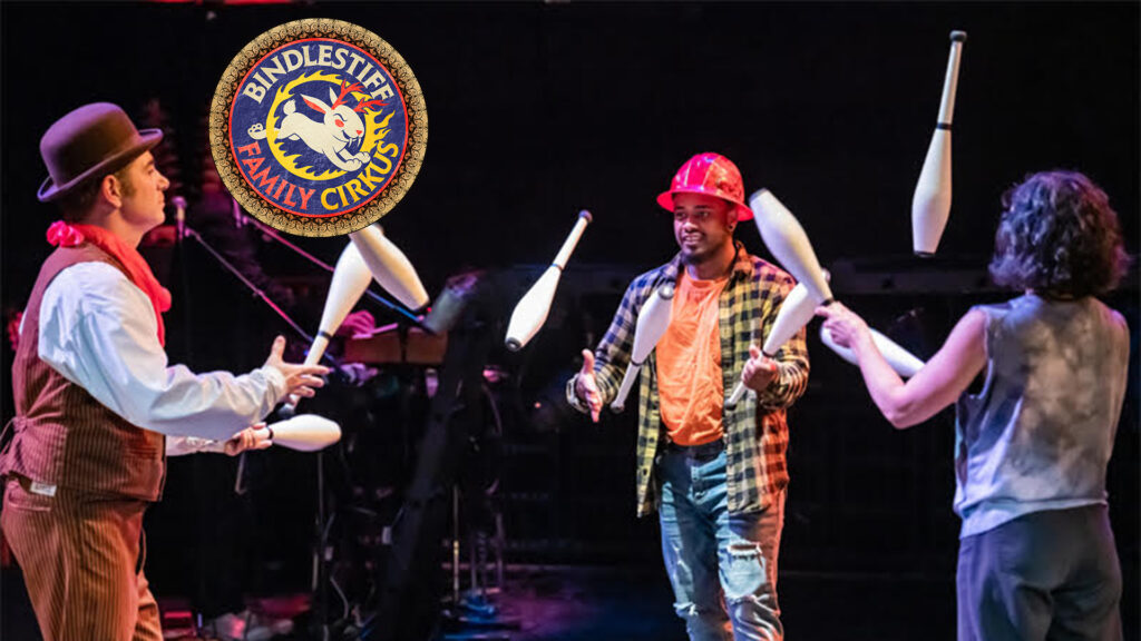 Three people juggle on stage, with the Bindlestiff Family Cirkus logo visible.