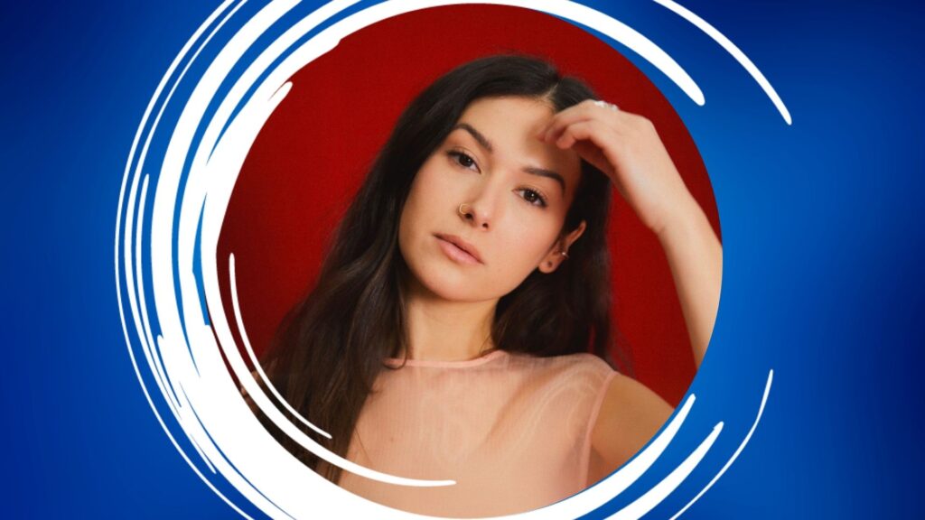 Portrait of a woman against a red background with a blue and white circular frame.