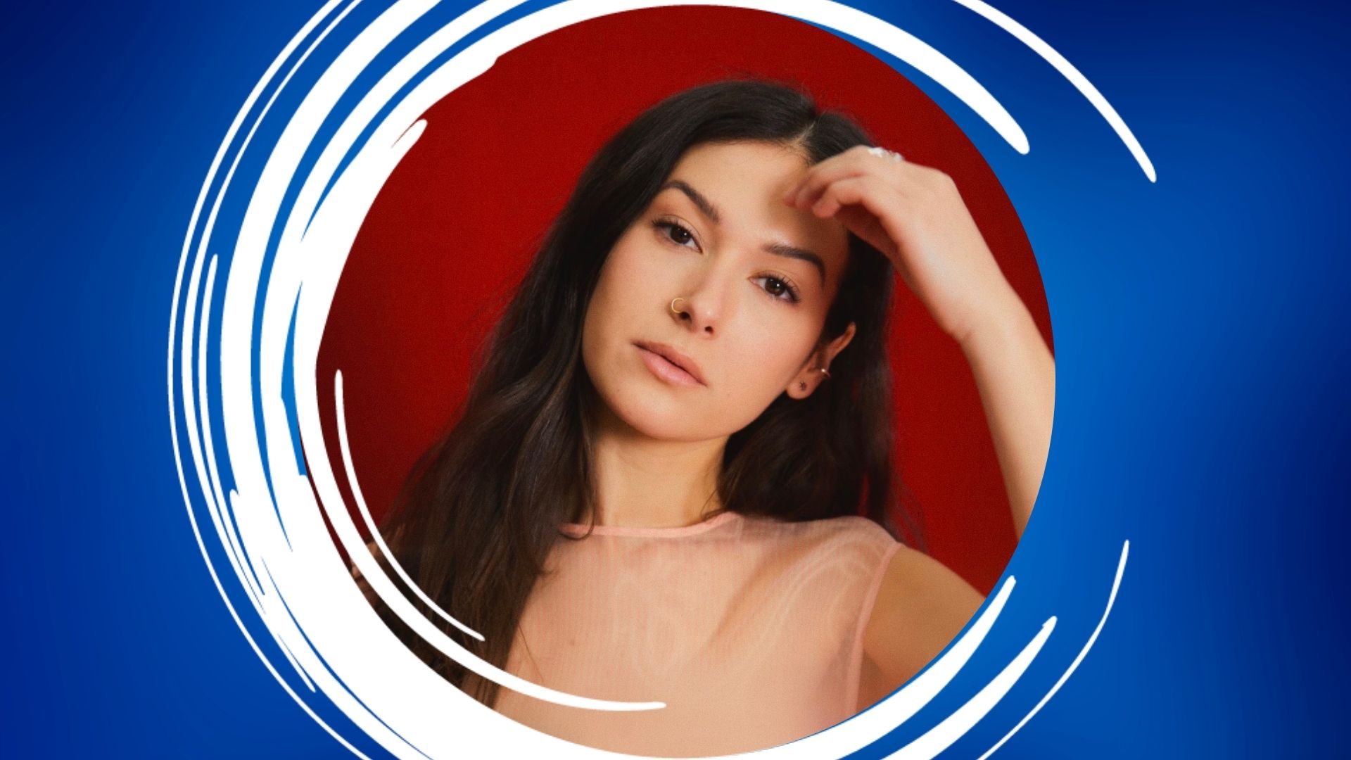 Nella – 1920×1080 Feature Portrait of a woman against a red background with a blue and white circular frame.