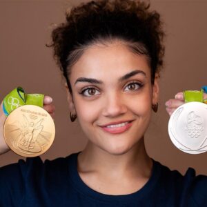 A person holding a gold and a silver Olympic medal.