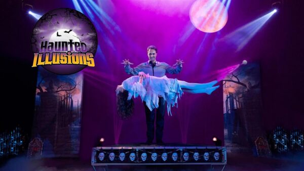 A magician levitates a woman on a stage with dramatic lighting and eerie decorations.