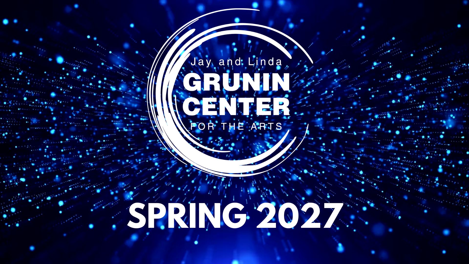 Promotional graphic for the Jay and Linda Grunin Center for the Arts announcing “Spring 2027,” set against a glowing blue particle background.